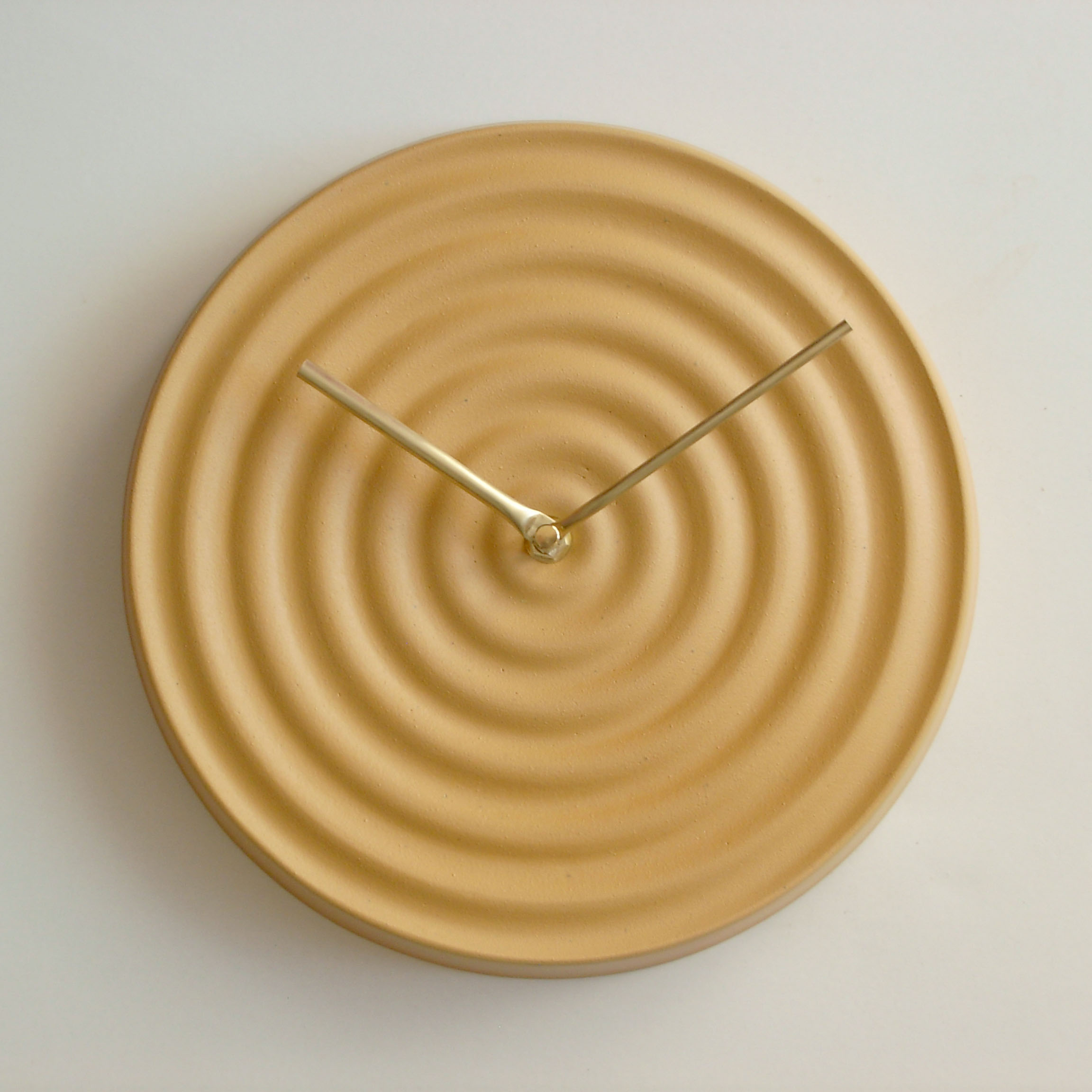 The minimal wall clock around it is yellow