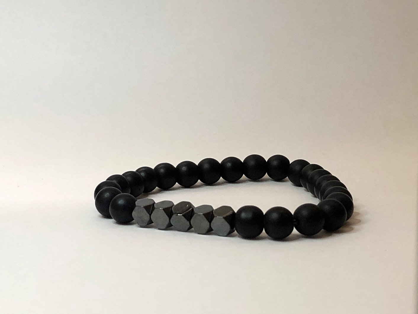 Matte black onyx bracelet with round charcoal cube