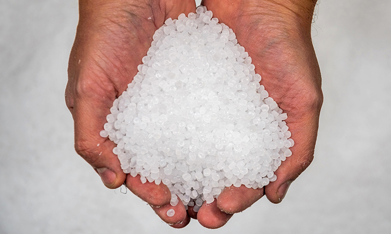 Hands of a worker hold granules for the production of plastic ba پلی اتیلن سبک LFI 2119 - Image 1